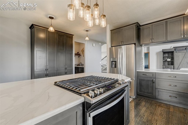 kitchen featuring hanging light fixtures, dark hardwood / wood-style floors, and appliances with stainless steel finishes