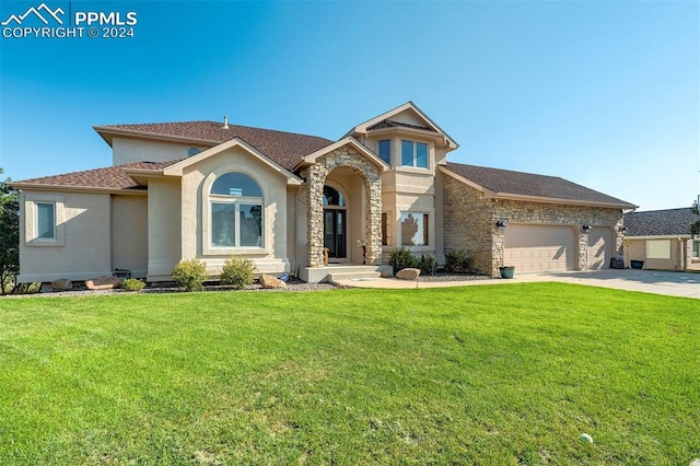 view of front of home featuring a garage and a front lawn