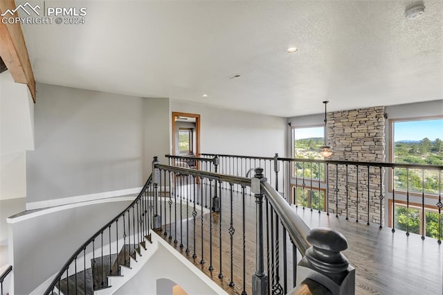 stairs with hardwood / wood-style flooring and a textured ceiling