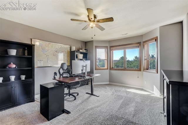 home office with light carpet and ceiling fan