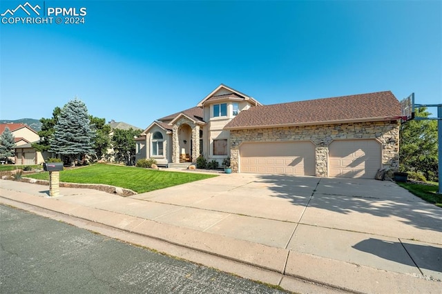 view of front of property with a garage and a front lawn