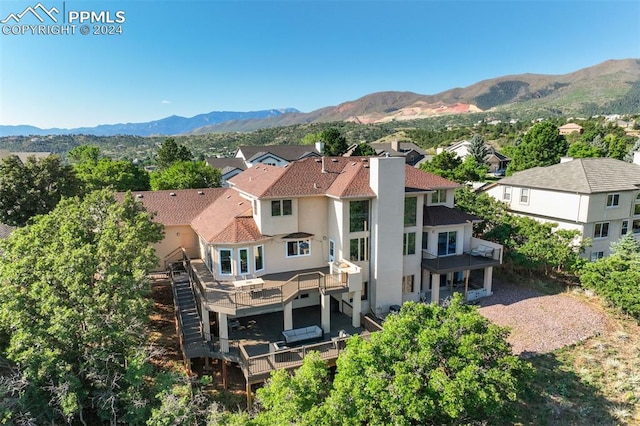 back of house featuring a balcony and a mountain view