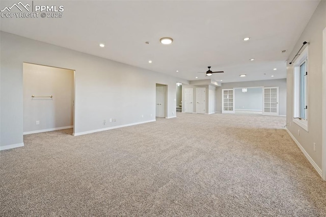 unfurnished living room with light carpet and ceiling fan