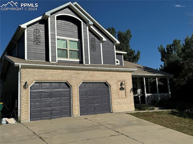 view of front of property with covered porch and a garage