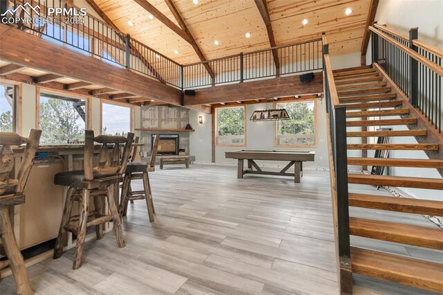 unfurnished dining area featuring billiards, beam ceiling, hardwood / wood-style flooring, and wood ceiling