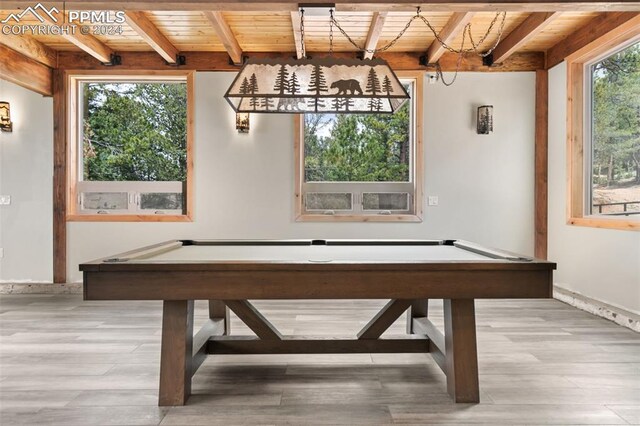 bar with beam ceiling, wooden ceiling, and light hardwood / wood-style floors