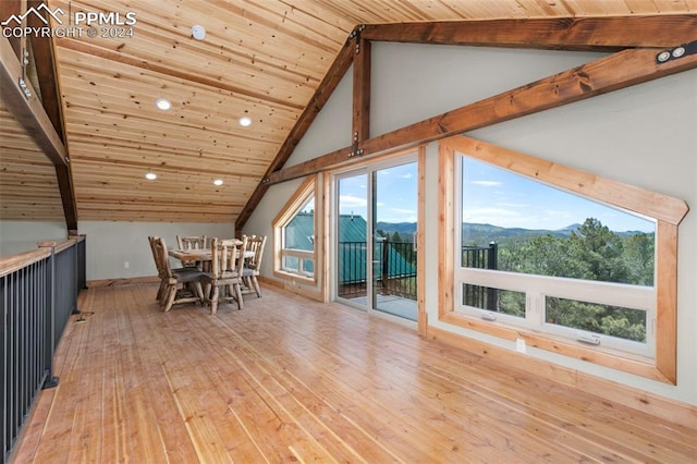 unfurnished dining area with light wood-type flooring, wood ceiling, beamed ceiling, and a healthy amount of sunlight