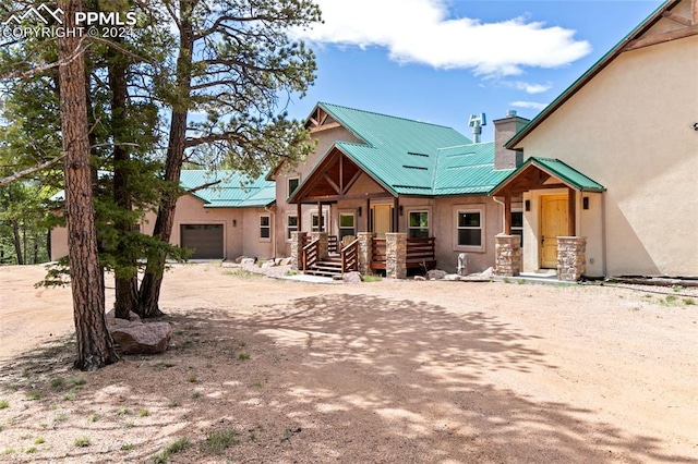 view of front of house with a porch and a garage