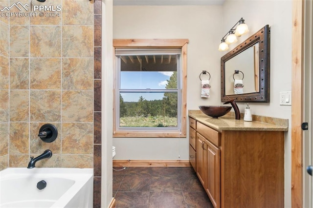 bathroom with vanity, toilet, and a bath