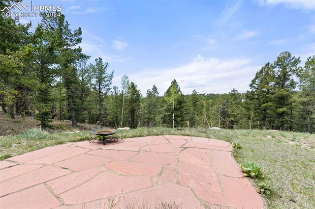 back of property with a lawn, a patio area, and a deck