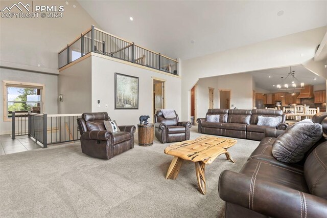 carpeted living room featuring high vaulted ceiling and a stone fireplace