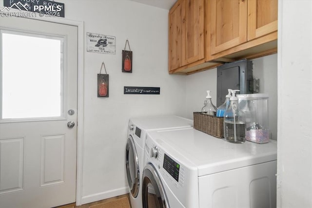 laundry area featuring cabinets and washer and clothes dryer