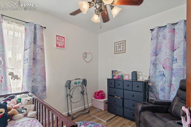 bedroom with ceiling fan and wood-type flooring