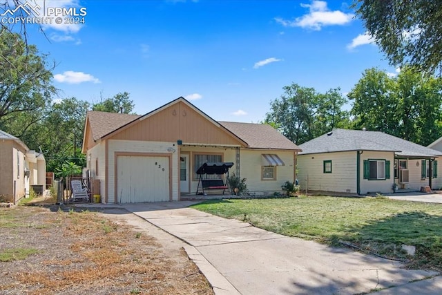 single story home featuring a garage and a front yard