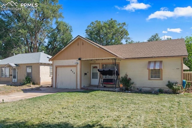 view of front of property with a garage and a front yard