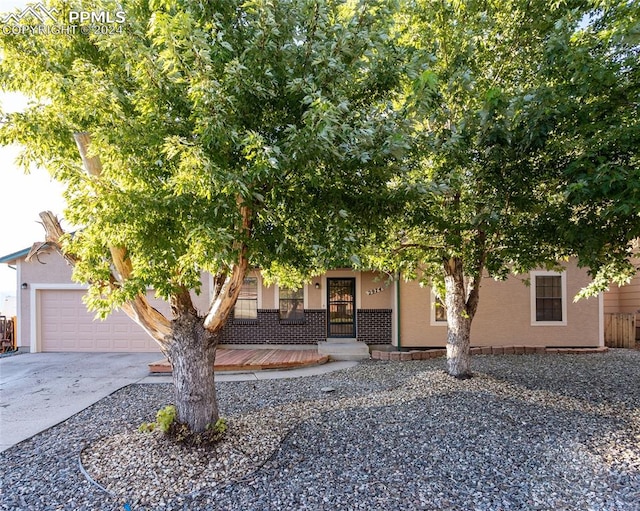 view of property hidden behind natural elements with a garage