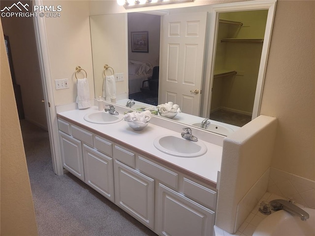 bathroom with vanity and a washtub