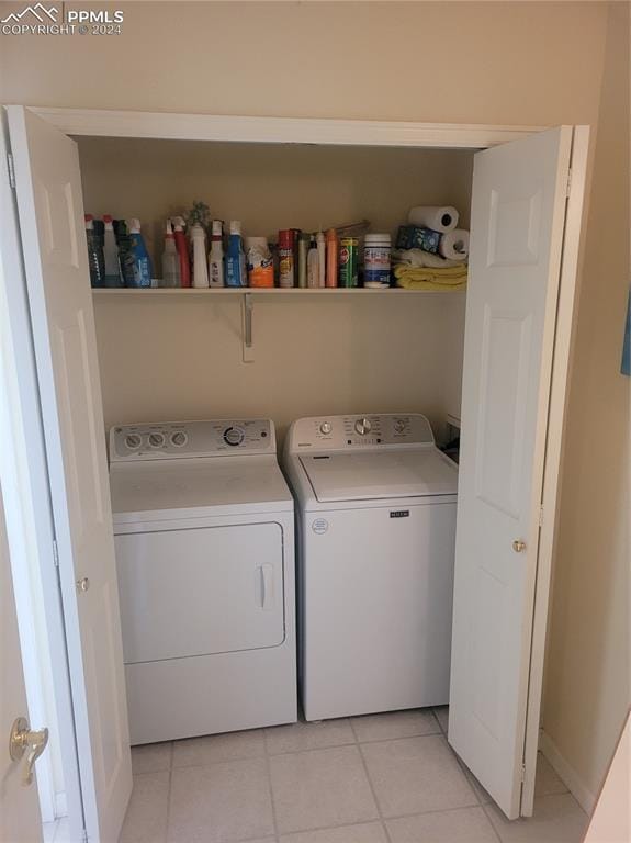 washroom featuring independent washer and dryer and light tile patterned floors