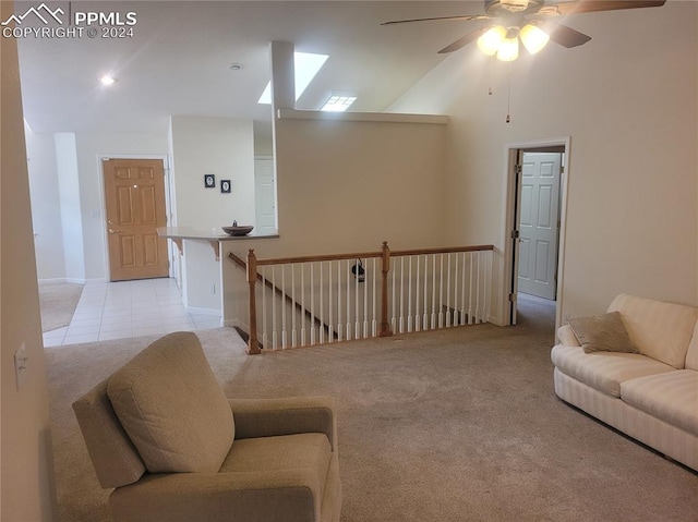 living room with light carpet, high vaulted ceiling, and ceiling fan