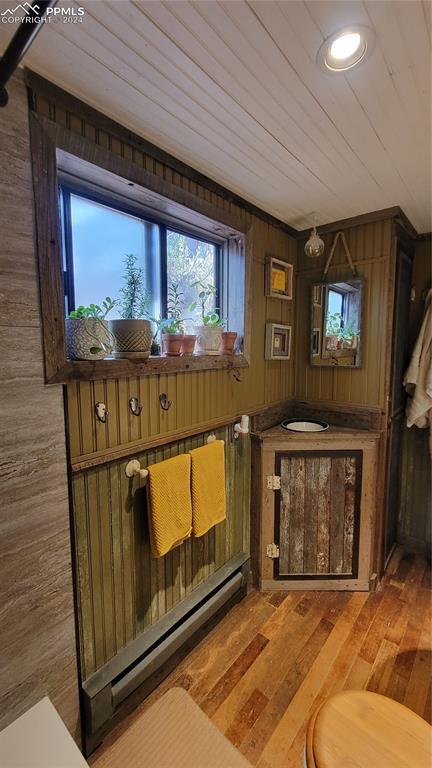 231 Plainview Pl, Manitou Springs, CO 80829 - interior space with a baseboard heating unit, hardwood / wood-style flooring, wood walls, wood ceiling, and recessed lighting
