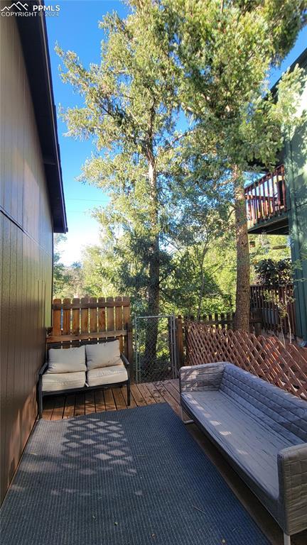 231 Plainview Pl, Manitou Springs, CO 80829 - wooden terrace with an outdoor hangout area and fence