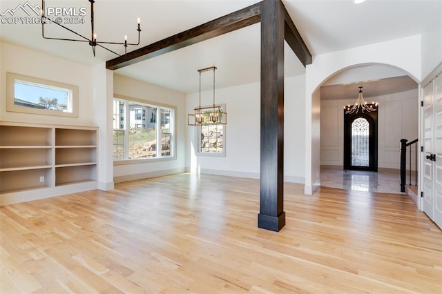 entrance foyer with beamed ceiling and light wood-type flooring