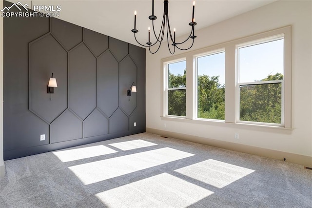 unfurnished dining area with a chandelier and carpet flooring