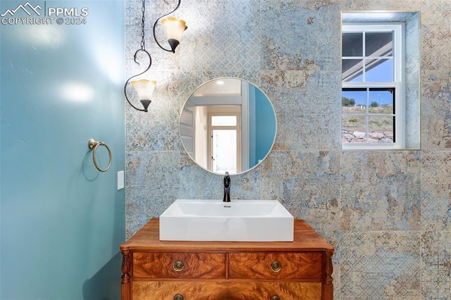 bathroom with tile walls and vanity