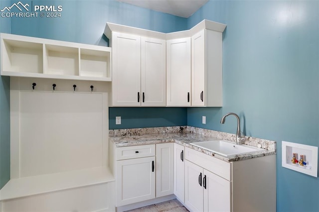 washroom featuring cabinets, sink, and washer hookup