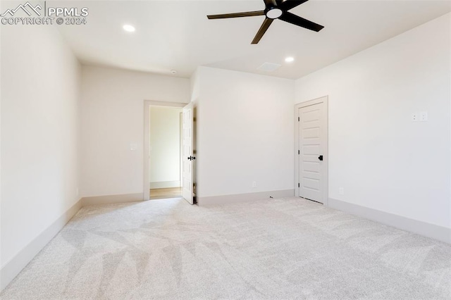 empty room with light colored carpet and ceiling fan