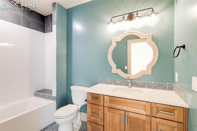 full bathroom featuring toilet, tiled shower / bath combo, vanity, and tile patterned flooring