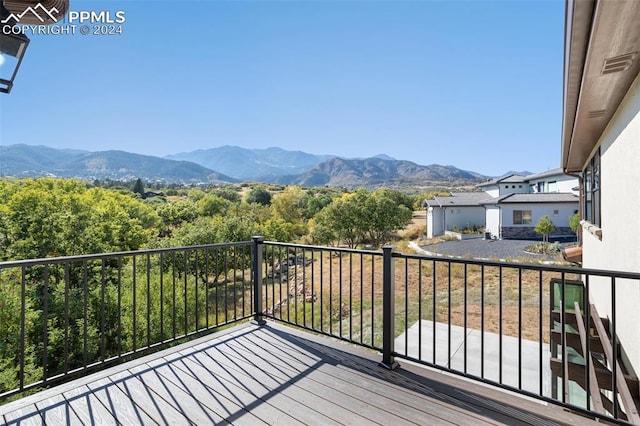 wooden deck with a mountain view