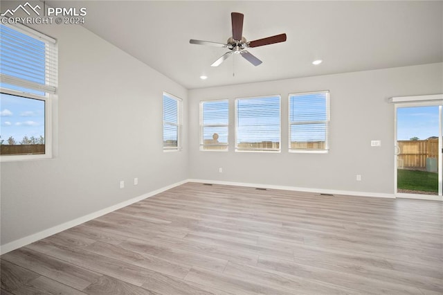 spare room with a healthy amount of sunlight, light hardwood / wood-style flooring, and ceiling fan