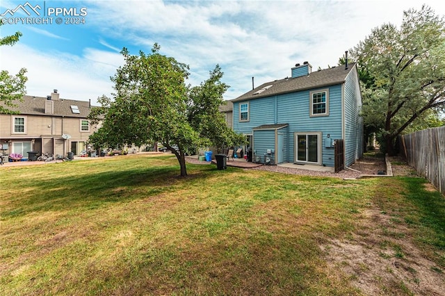 rear view of house with a yard