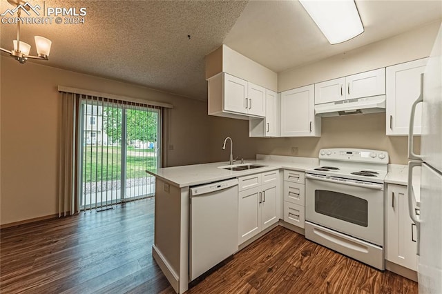 kitchen with white cabinetry, white appliances, kitchen peninsula, sink, and dark wood-type flooring