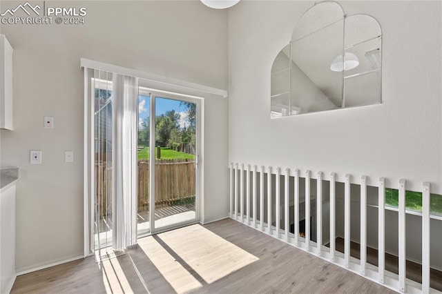 interior space with high vaulted ceiling and wood-type flooring