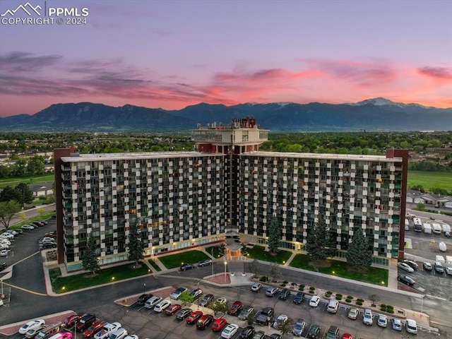 aerial view at dusk featuring a mountain view