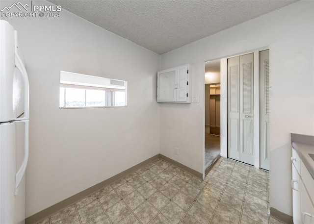 spare room with a textured ceiling