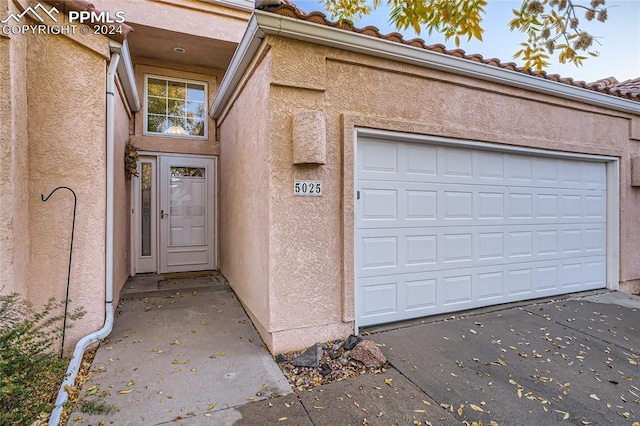 view of exterior entry with a garage