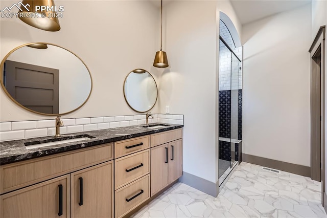 bathroom featuring vanity and a shower with shower door