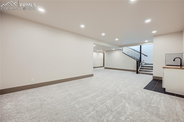 basement featuring dark colored carpet