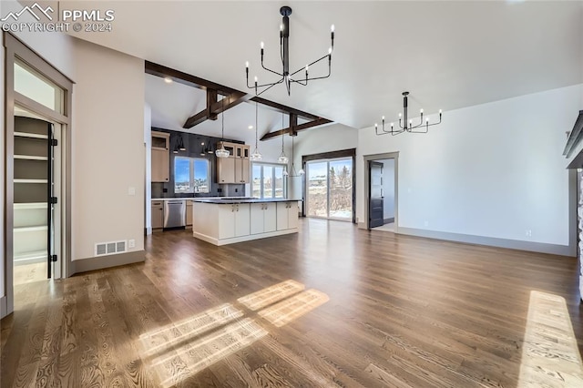 kitchen featuring dishwasher, hardwood / wood-style floors, a center island, and lofted ceiling with beams