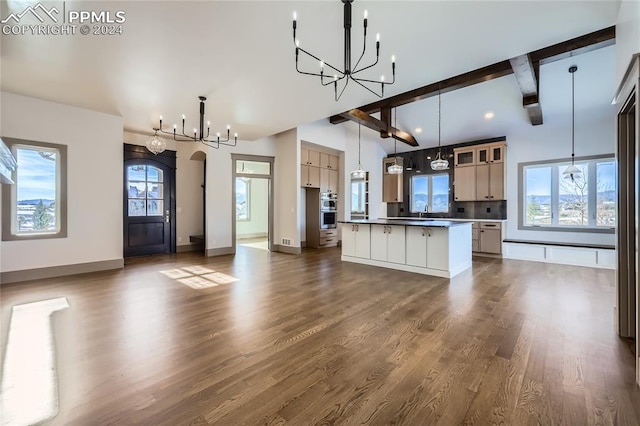 kitchen with a wealth of natural light, dark hardwood / wood-style flooring, a kitchen island, and pendant lighting