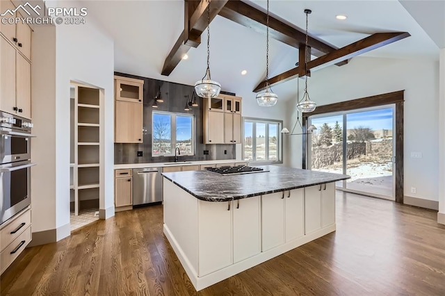 kitchen featuring a center island, hanging light fixtures, appliances with stainless steel finishes, beam ceiling, and dark hardwood / wood-style flooring