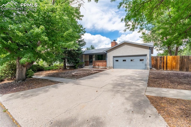 ranch-style home featuring a garage