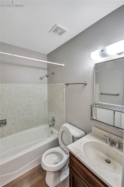 full bathroom featuring toilet, tub / shower combination, vanity, and hardwood / wood-style flooring