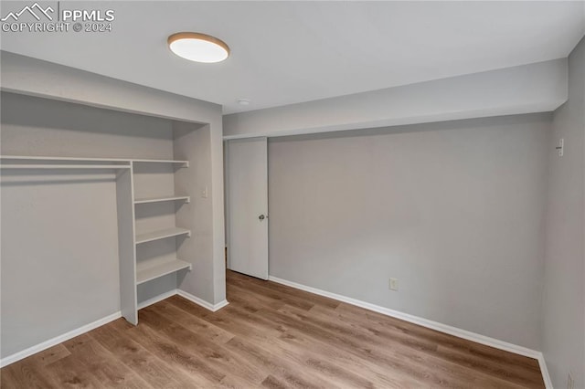 basement with hardwood / wood-style floors