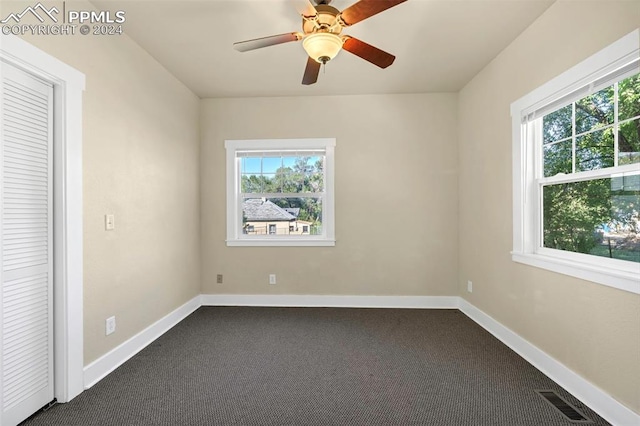 empty room featuring carpet flooring and ceiling fan