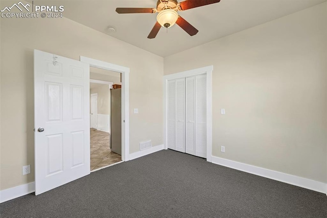 unfurnished bedroom with a closet, ceiling fan, and dark colored carpet