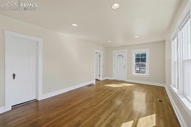 unfurnished room with hardwood / wood-style flooring